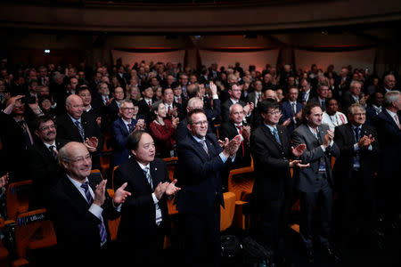 Scientists celebrate after the vote on the redefinition of four base units of the International System of Units (SI) during the 26th meeting of the General Conference on Weights and Measures (CGPM) in Versailles, France, November 16, 2018. REUTERS/Benoit Tessier