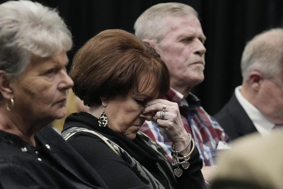 Debra Wyatt, center, the daughter of murder victims AJ and Patsy Cantrell, listens during clemency proceedings Wednesday, Dec. 7, 2022, in Oklahoma City, for Scott Eizember, who was convicted of several crimes and sentenced to death for the 2003 murder of AJ Cantrell. At left is Wyatt's friend Cindy Hightower, at right is her husband, Terry Wyatt. (AP Photo/Sue Ogrocki)