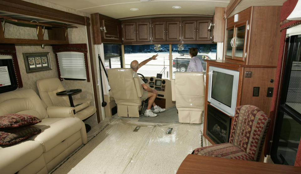 ** FILE ** Ron and Colleen Colbach check out a $223,000 Winnebago recreational vehicle at Motor Sportsland in Salt Lake City in this June 12, 2007 file photo.  The Colbachs divide their lives between Utah and Arizona.  Winnebago Industries Inc. on Thursday, Dec. 20, 2007 said its profit rose about 26 percent in the first quarter as more customers bought more profitable high-end motor homes and the company spent less on promotions. It also boosted its dividend and its shares rose more than 4 percent in morning trading. (AP Photo/Douglas C. Pizac, file)