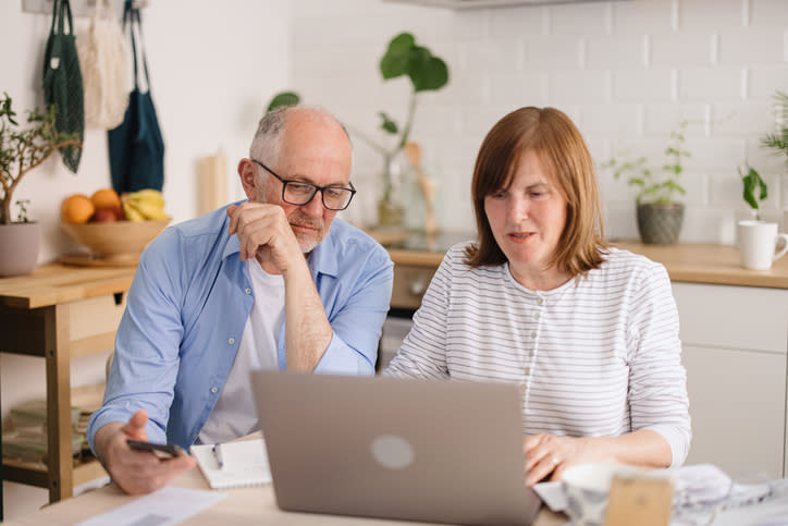 A couple making adjustments to their budget so that they can allocate more money to different goals.