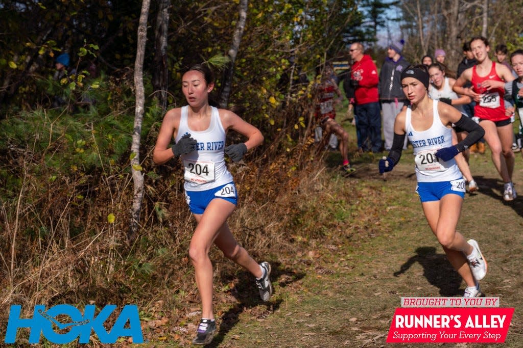 Oyster River High School cross country runners Haley Kavanagh (left) and Mackenzie Cook (right) running the Troy Howard Middle School course in the 2023 New England Cross Country Championship.