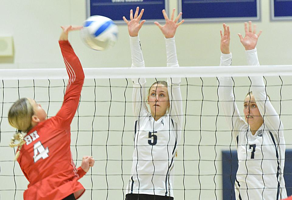 Great Plains Lutheran sisters Kate (5) and Olivia Holmen (7) attempt to block Britton-Hecla's Karlie Zuehlke during their high school volleyball match on Tuesday, Oct. 17, 2023 in Watertown.