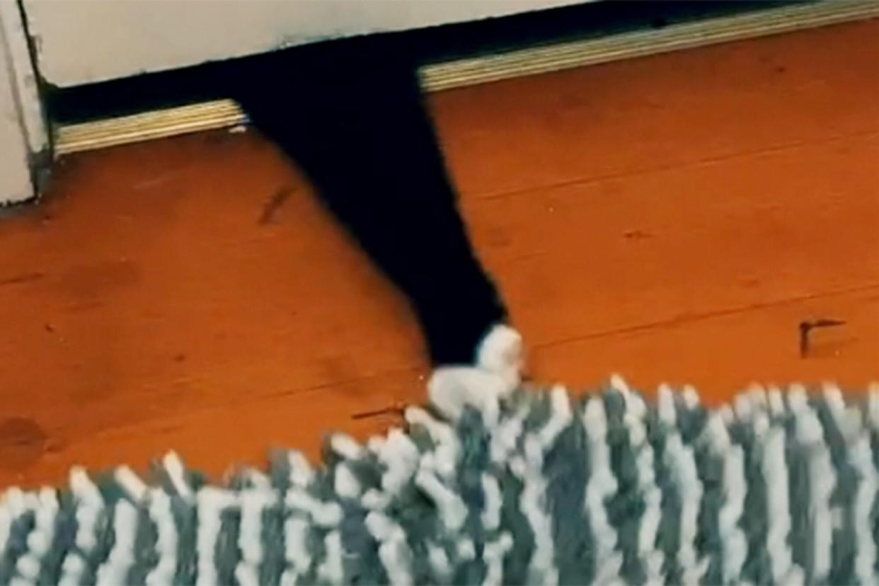 cat pulling rug from under the door when he's not happy with owner for going into the bathroom without him