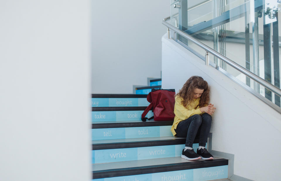 young kid alone on the stairs upset