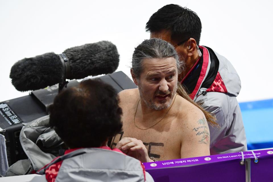 <p>A shirtless man clad in a tutu is escorted off the rink following the men’s 1,000m speed skating event medal ceremony during the Pyeongchang 2018 Winter Olympic Games at the Gangneung Oval in Gangneung on February 23, 2018. / AFP PHOTO / Roberto SCHMIDT </p>