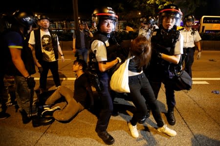 Police officers detain protesters during a protest to demand authorities scrap a proposed extradition bill with China, on Gloucester Road in Hong Kong