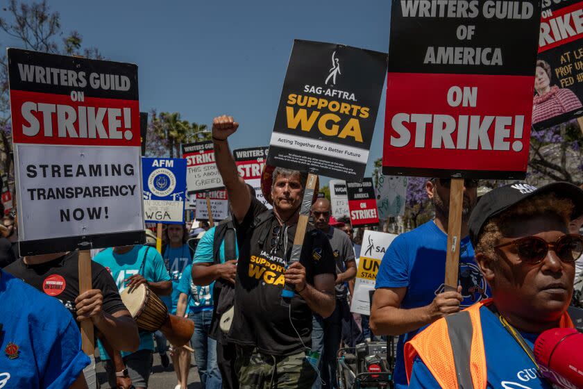 LOS ANGELES, CA - JUNE 21: Striking members of the Writers Guild of America and supporters march towards La Brea Tar Pits, Los Angeles, CA. (Irfan Khan / Los Angeles Times)