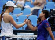 Mona Barthel (L) of Germany shakes hands with Luksika Kumkhum of Thailand after winning their women's singles match at the Australian Open 2014 tennis tournament in Melbourne January 15, 2014. REUTERS/David Gray