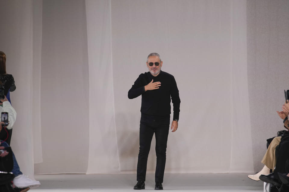 Designer Elie Saab accepts applause at the end of the Elie Saab Haute Couture Spring-Summer 2023 collection presented in Paris, Wednesday, Jan. 25, 2023. (AP Photo/Christophe Ena)