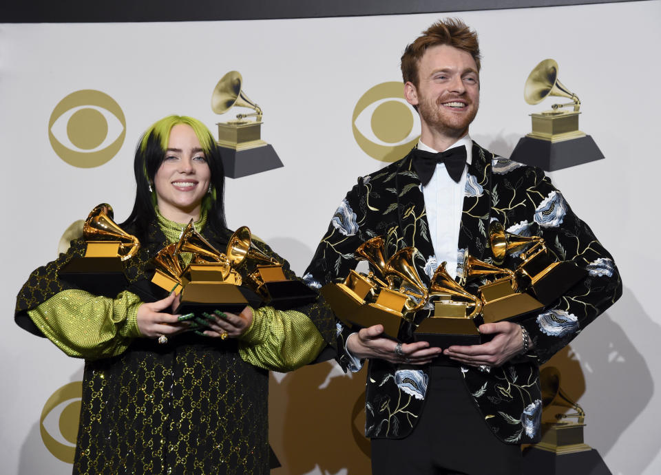 Billie Eilish, left, and Finneas O'Connell pose in the press room with the awards for best album, best engineered album and best pop vocal album for "We All Fall Asleep, Where Do We Go?," best song and record for "Bad Guy," best new artist and best producer, non-classical at the 62nd annual Grammy Awards at the Staples Center on Sunday, Jan. 26, 2020, in Los Angeles. (AP Photo/Chris Pizzello)