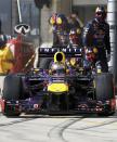 Red Bull Formula One driver Sebastian Vettel of Germany pulls out of the pits as his crew looks onduring the U.S. F1 Grand Prix at the Circuit of the Americas in Austin, Texas November 17, 2013.