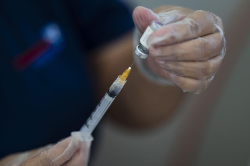 A healthcare worker prepares a dose of the Johnson & Johnson COVID-19 vaccine during a vaccination campaign as part of the “Noche de San Juan” festivities, a traditional all-day celebration to mark the birth of St. John the Baptist, at the Ultimo Trolley public beach in San Juan, Puerto Rico, Wednesday, June 23, 2021. This year COVID-19 vaccines will be available to devotees heading to the beach to celebrate the saint’s June 24th feast day. (AP Photo/Carlos Giusti)