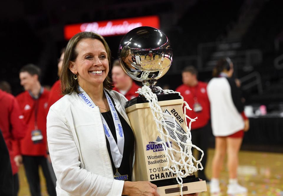 South Dakota women's basketball head coach Dawn Plitzuweit holds the Summit League trophy and game net after winning the tournament for the third year running on Tuesday, March 8, 2022, at the Denny Sanford Premier Center in Sioux Falls.