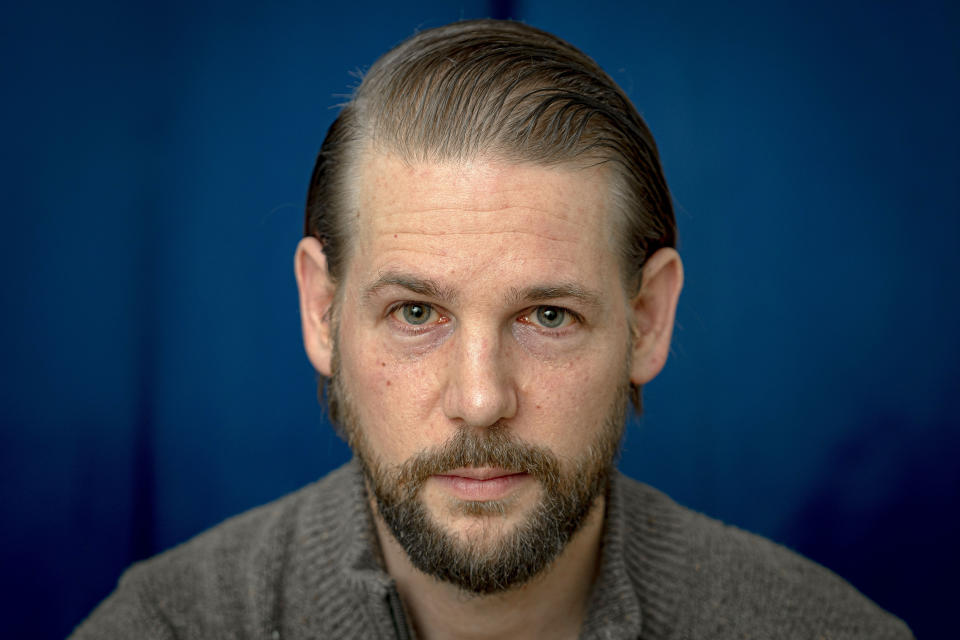 Steve Caccamo, a former student at the Academy at Ivy Ridge, poses for a photo in his apartment, Thursday, March 28, 2024, in New York. A Netflix docuseries spotlighting abuse allegations at the long-shuttered Academy at Ivy Ridge in rural northern New York has prompted dozens of new complaints to the local prosecutor and a fresh investigation. (AP Photo/Peter K. Afriyie)