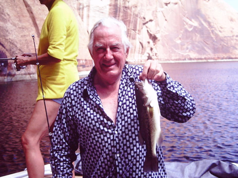 Chief Justice Warren Burger displays one of the fish he caught on Lake Powell.