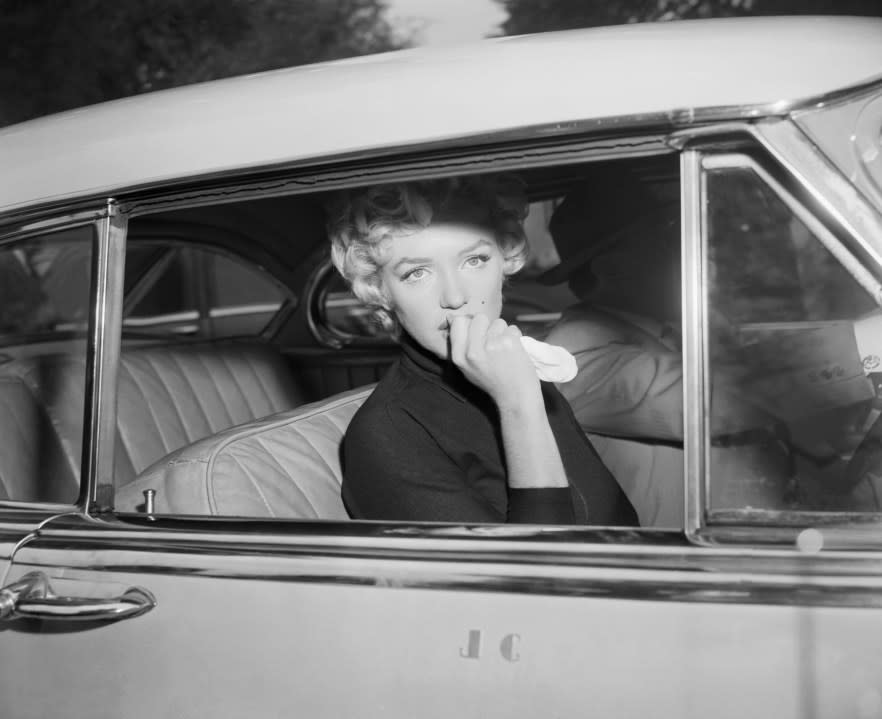 Marilyn Monroe leaves the home she briefly shared with Joe Di Maggio in a car driven by her attorney, Jerry Giesler. (Getty Images)