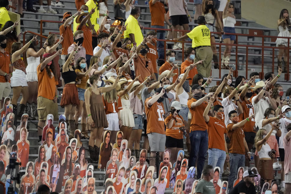 FILE - In this Saturday, Sept. 12, 2020, file photo, fans join in singing "The Eyes of Texas" after Texas defeated UTEP 59-3 in an NCAA college football game in Austin, Texas. The University of Texas' long-awaited report on the history of the school song “The Eyes of Texas” found it had “no racist intent,” but the school will not require athletes and band members to participate in singing or playing it at games and campus events. The song had erupted in controversy in 2020 after some members of the football team demanded the school stop playing it because of racist elements in the song’s past. (AP Photo/Chuck Burton, File)