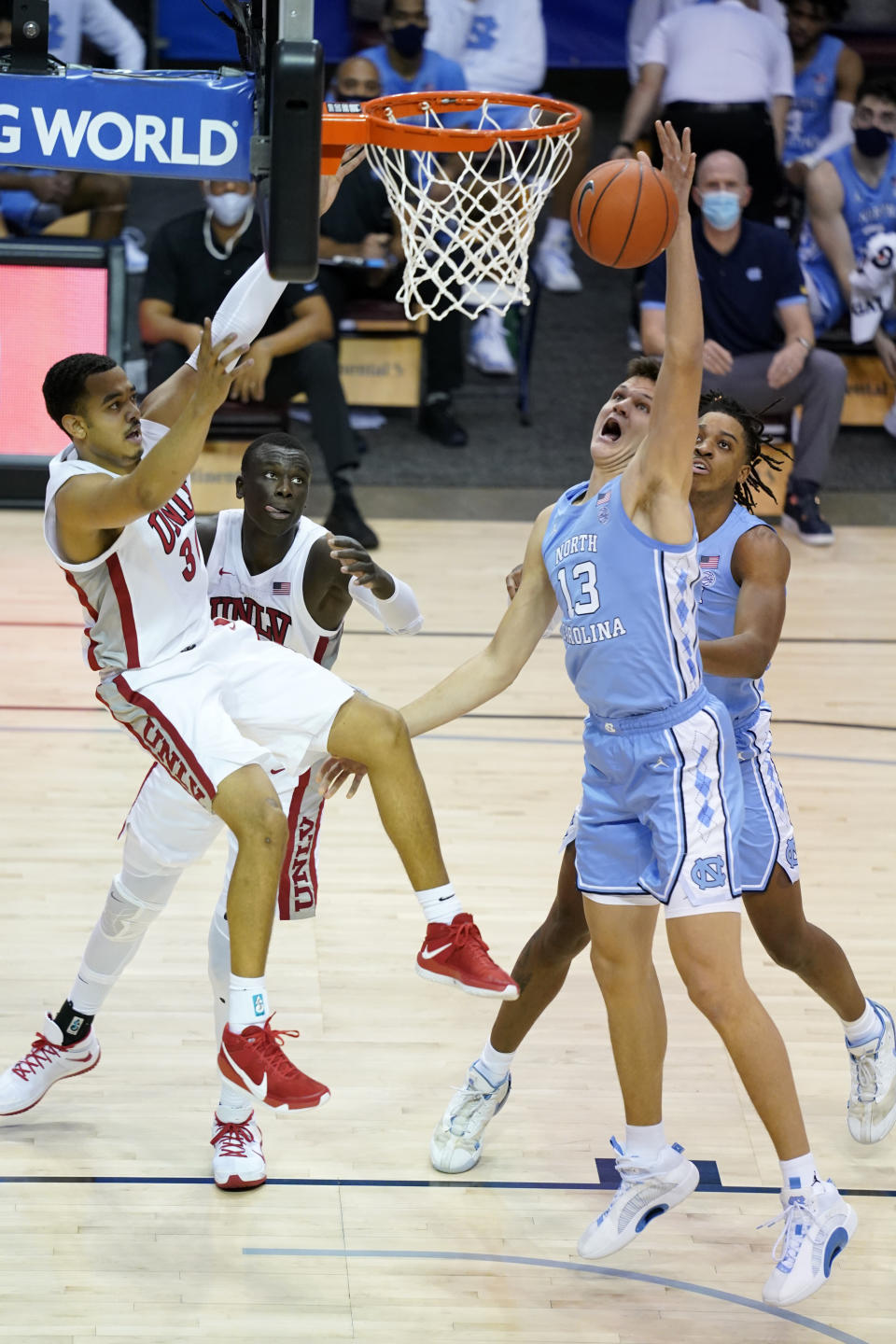 North Carolina forward Walker Kessler (13) reaches for a rebound in front of UNLV forward Devin Tillis (30) in the first half of an NCAA college basketball game in the Maui Invitational tournament, Monday, Nov. 30, 2020, in Asheville, N.C. (AP Photo/Kathy Kmonicek)