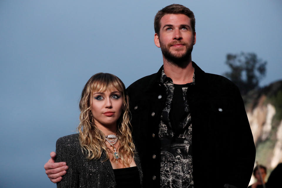 Miley Cyrus and Liam Hemsworth, then married, pose at the Saint Laurent Men&rsquo;s Spring/Summer 2020 fashion show on June 6, 2019. (Photo: Mario Anzuoni/Reuters)