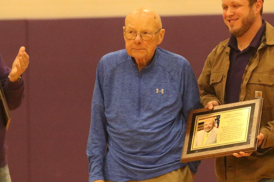 Robert Whitney, left, was honored before Friday's Mansfield Senior-Lexington boys basketball game with a plaque naming the new school's performing arts center after him. At the right is fellow school board member and Whitney's grandson Rob Schuster.