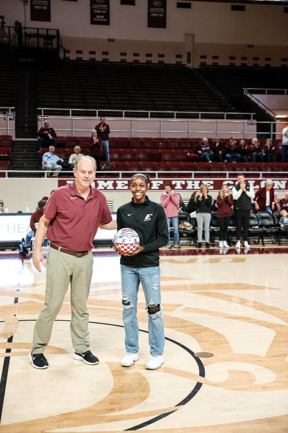 EKU coach Greg Todd and Antwainette Walker celebrate her reaching the 1,000-point mark for her career in December.