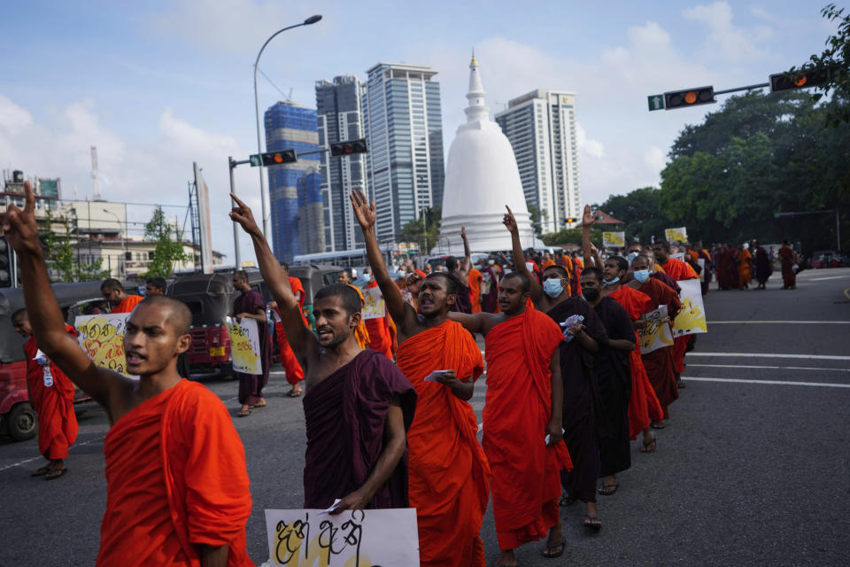 Sri Lankan student Buddhist monks shout slogans as they march demanding President Gotabaya Rajapaksa resign over the economic crisis in Colombo, Sri Lanka, Monday, June 20, 2022. (AP Photo/Eranga Jayawardena)