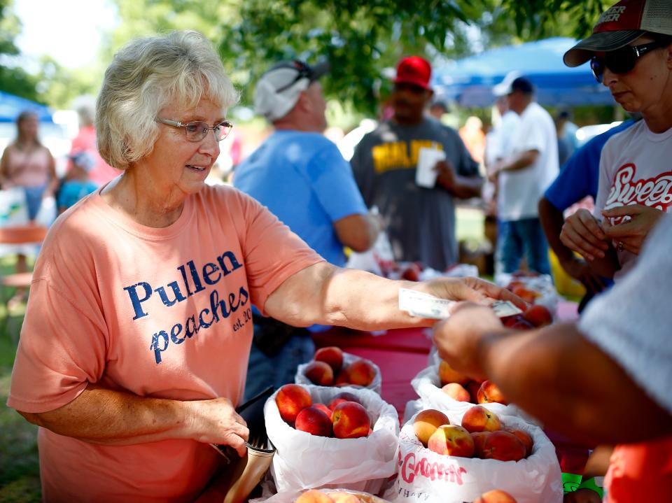 Sue Pullen with Pullen Farms sells peaches during the 2021 Stratford Peach Festival in Stratford.