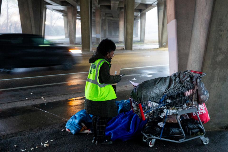 Andorian Thomas, a staff member from Project for Assistance in Transition from Homelessness with CMI Healthcare Services, speaks with an unhoused person that had been sleeping under a bridge in Downtown Memphis Thomas takes part in the annual point-in-time count led by Community Alliance for the Homeless in Memphis, Tenn., on Thursday, January 25, 2024.