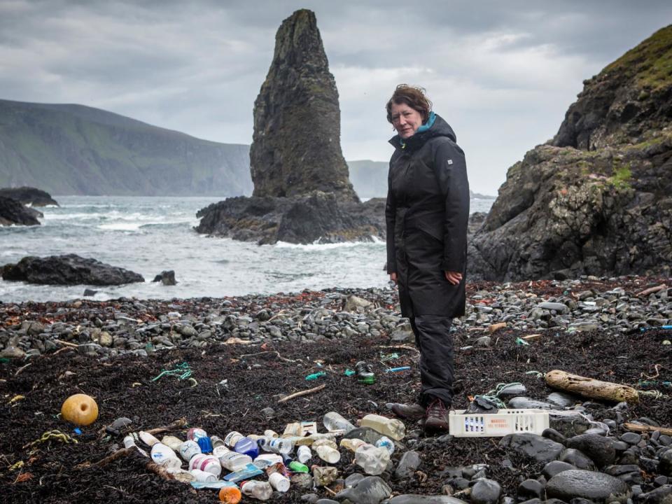 Artist Mandy Barker at a beach on Canna with a collection of some of the plastic rubbish found there (Will Rose/Greenpeace)