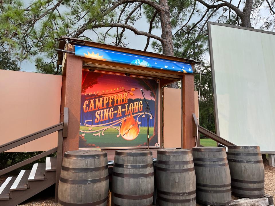 campfire sing along disney with barrels in front