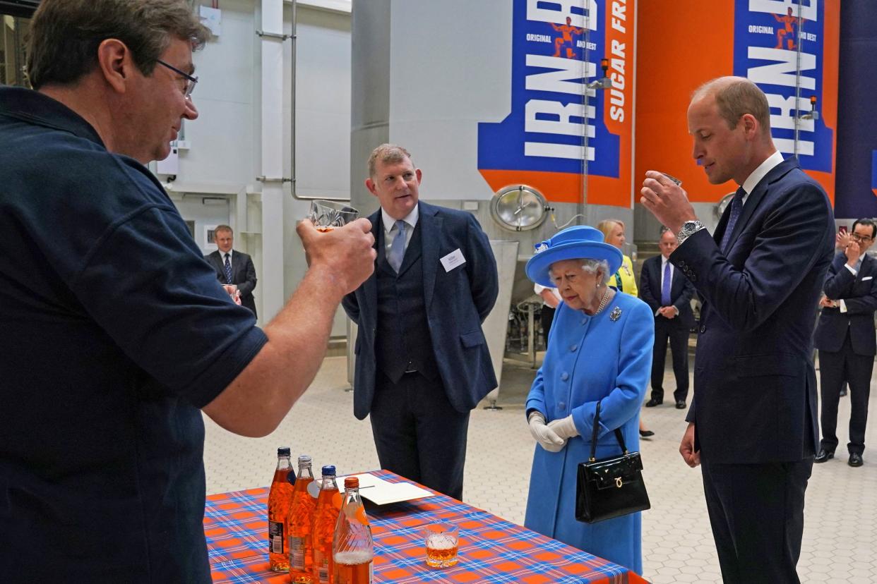 Britain's Prince William, Duke of Cambridge (R) samples Irn-Bru as he and Britain's Queen Elizabeth II  visit AG Barr's factory in Cumbernauld, east of Glasgow, where the Irn-Bru drink is manufactured on June 28, 2021. - The Queen is in Scotland for Royal Week where she will be undertaking a range of engagements celebrating community, innovation and history. (Photo by Andrew Milligan / POOL / AFP) (Photo by ANDREW MILLIGAN/POOL/AFP via Getty Images)