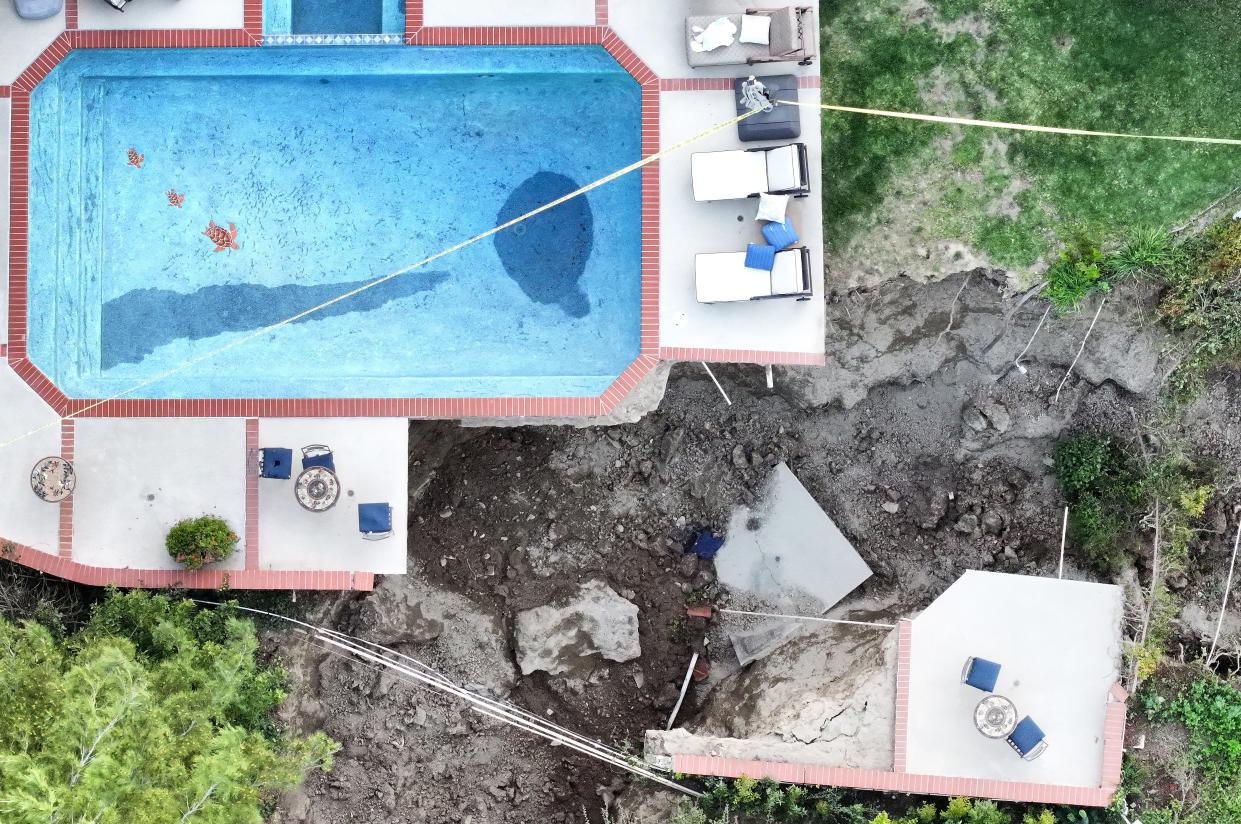 An aerial view shows a pool remaining above a large fissure after a landslide destroyed one home and damaged two others in the Sherman Oaks neighborhood on March 13, 2024 in Los Angeles, California.