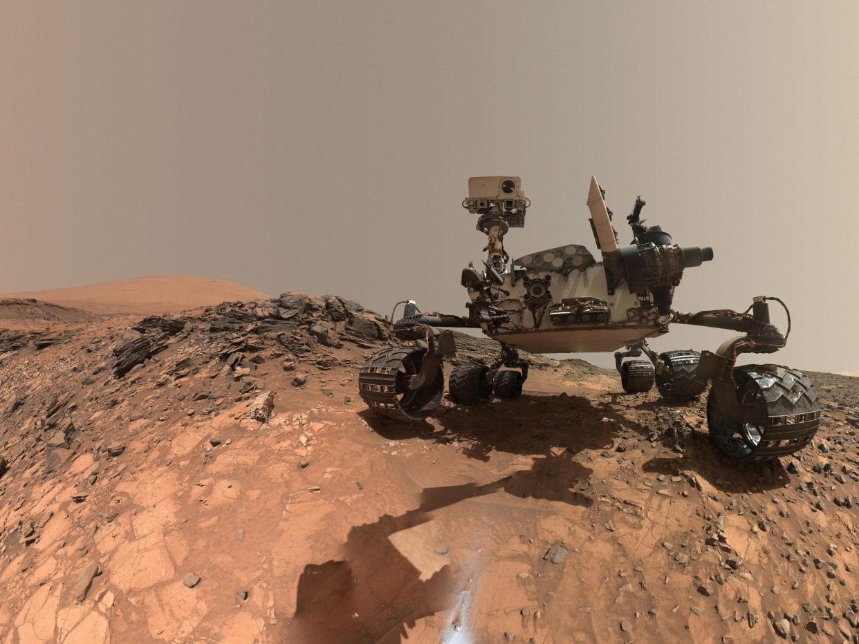 'Curiosity' at the site from which it reached down to drill into a rock target called "Buckskin" on lower Mount Sharp: AFP