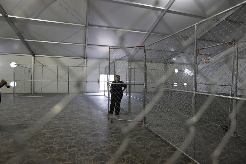 FILE--In this Dec. 7, 2016 file photo, a U.S. Customs and Border Protection agent stands in a temporary holding facility near the Donna-Rio Bravo International Bridge in Donna, Texas. The U.S. government is working to open two new large tent facilities to temporarily detain up to 1,000 migrant parents and children near the southern border. U.S. Customs and Border Protection said in a notice to potential contractors that it's seeking to build large tents in El Paso, Texas, and in South Texas that could house 500 people at a time. The notice says families would sleep on mats inside each tent. (AP Photo/Eric Gay, File)