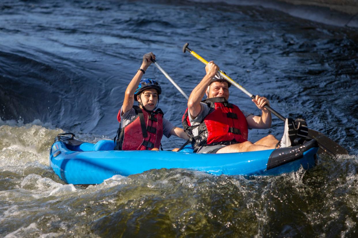 Peter Dolezal, 14, and his dad, Timothy, paddle down South Bend's East Race Waterway during the Urban Adventure Games on July 30, 2022.