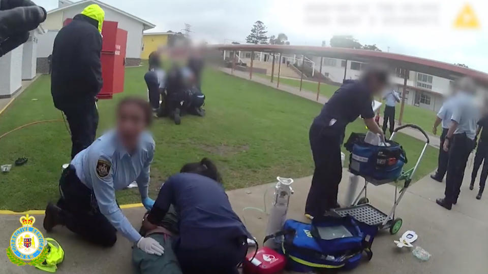 Paramedics working on several inmates and officers after the fires at Mary Wade Correctional Centre.