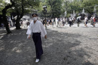 Visitors queue to enter Yasukuni Shrine Saturday, Aug. 15, 2020, in Tokyo. Japan marked the 75th anniversary of the end of World War II. (AP Photo/Eugene Hoshiko)