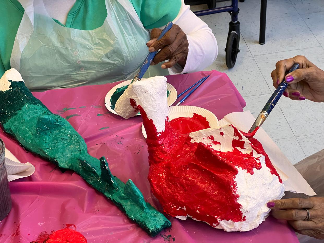 Telfair Museums' Outreach Program participants work to paint their beasts.