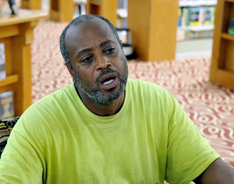 Tiras Tatum finds a cool spot in the Wayne County Public Library. The Wooster resident said he'd "probably be sweating around at home" without the public facility.