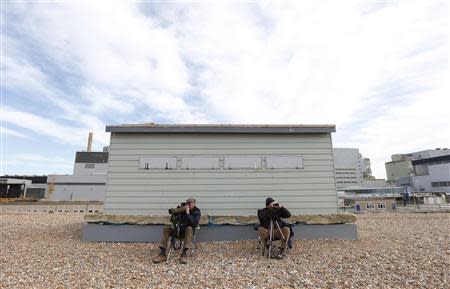 Birdwatchers Malcolm McVail (L) and Barry Woolhouse look through their binoculars outside Dungeness nuclear power station in Kent, southern England April 30, 2013. REUTERS/Suzanne Plunkett