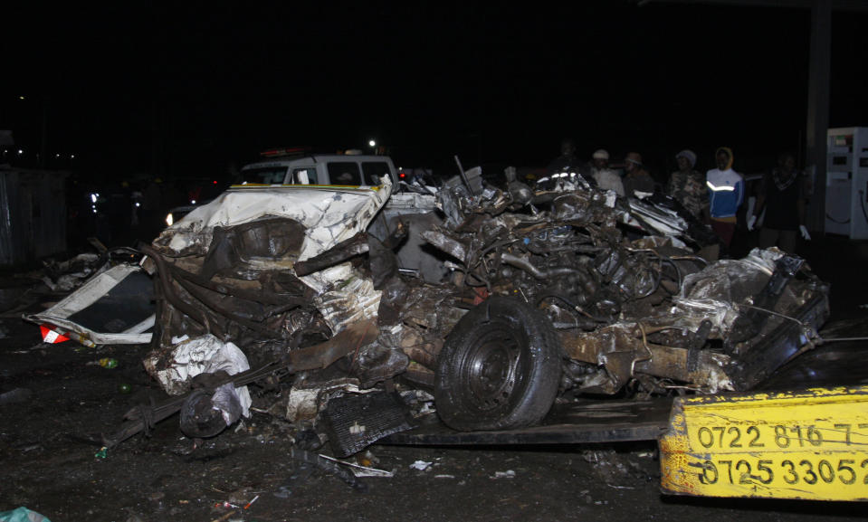 The wreckage of vehicles lies on the ground after a fatal accident in Londiani, Kenya early Saturday, July 1, 2023, at a location known for crashes about 200 kilometers (125 miles) northwest of the capital, Nairobi. Dozens were killed when a truck rammed into several other vehicles and market traders on Friday evening, police said. (AP Photo)