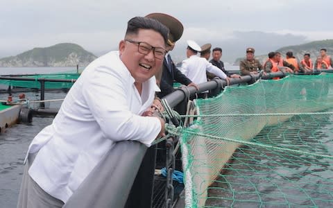 The North Korean leader's mood appeared to have improved during his visit to the Rajin salmon - Credit:  AFP