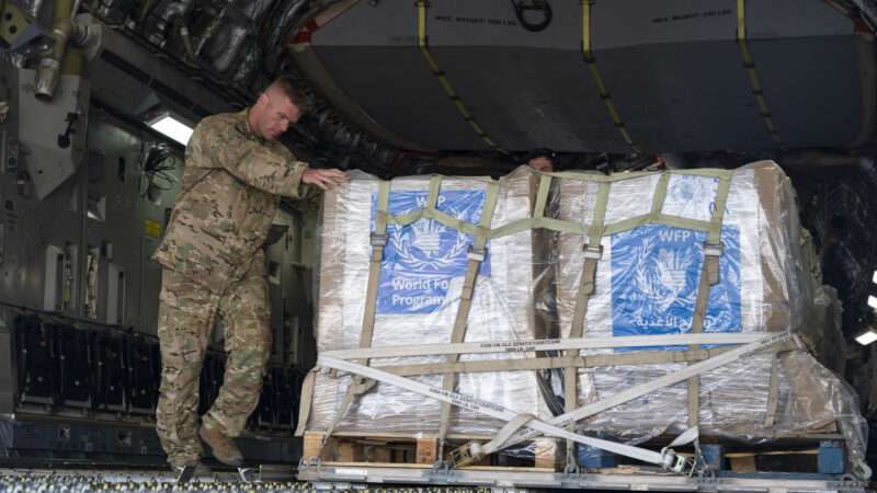 An Air Force member offloading packages from an aircraft