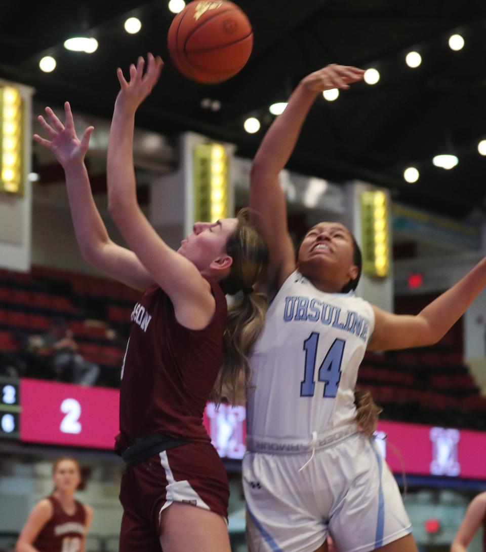 From right, Ursuline's Madison Stores (14) knocks the ball away from Harrison's Harper Lapin (4) as she drives to the basket during the Section1 Class AA girls basketball semifinal at the Westchester County Center in White Plains Feb. 27, 2024.