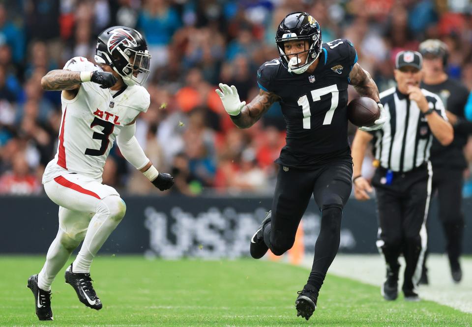 Evan Engram #17 of the Jacksonville Jaguars runs from Jessie Bates III #3 of the Atlanta Falcons in the fourth quarter during the NFL match between Atlanta Falcons and Jacksonville Jaguars at Wembley Stadium. (Photo by Stephen Pond/Getty Images)