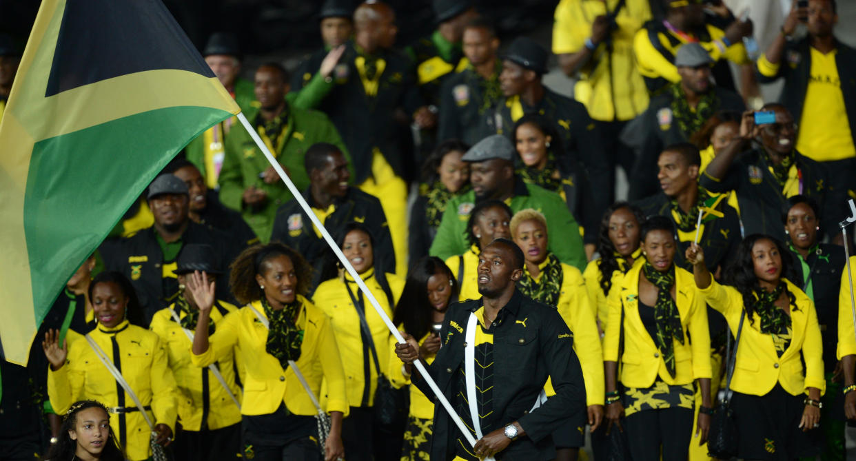 Jamaica's flagbearer Usain Bolt leads his delegation during the opening ceremony of the London 2012 Olympic Games in the Olympic Stadium in London on July 27, 2012.    AFP PHOTO / CHRISTOPHE SIMON        (Photo credit should read CHRISTOPHE SIMON/AFP/GettyImages)