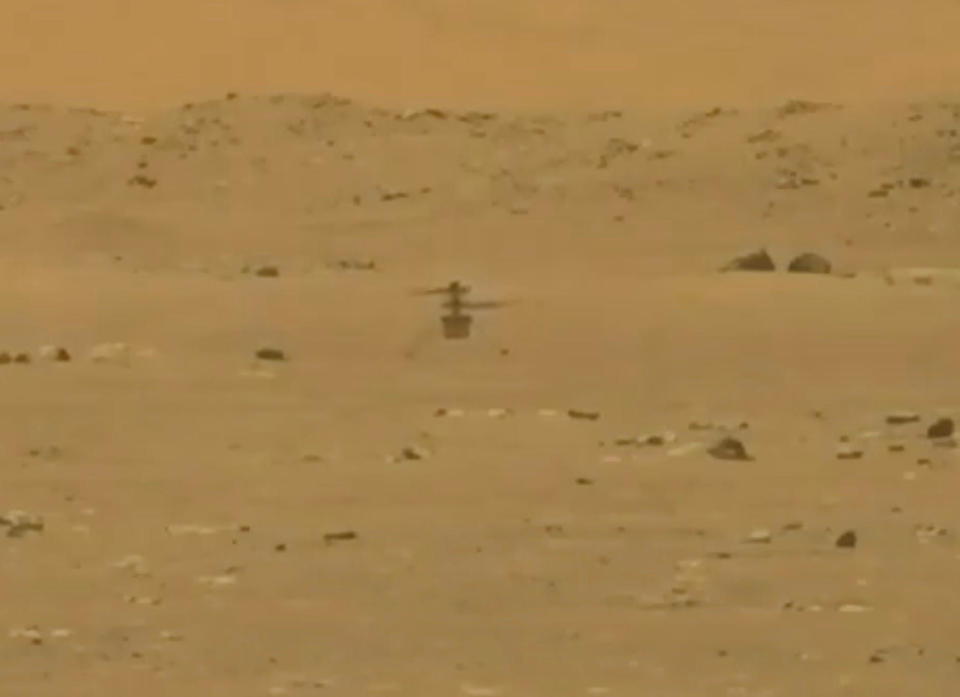 NASA's Mars helicopter Ingenuity is seen during its first flight on the planet in this still image taken from a video on April 19, 2021.  / Credit: NASA/JPL-Caltech/ASU