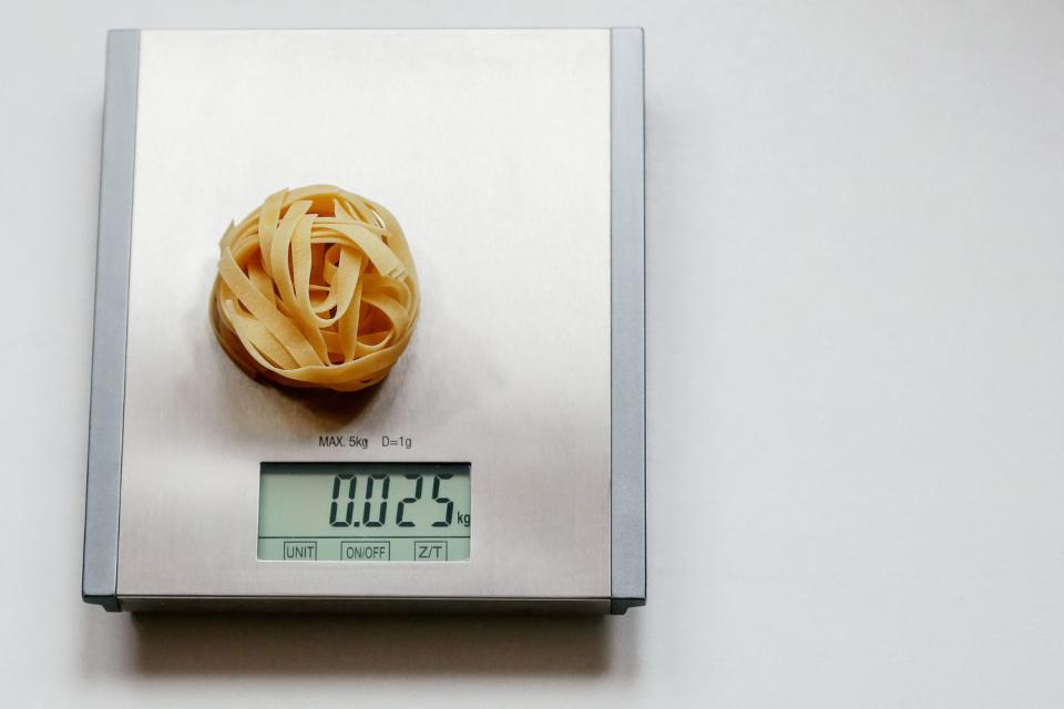 Measuring out portion sizes of pasta. (Getty Images)