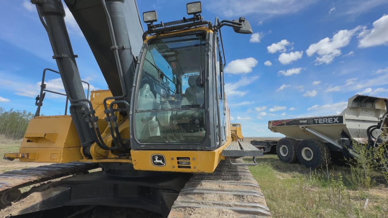 An excavator sits at a site in west Edmonton where Abalone Group of Companies is preparing the land for a new residential subdivision. (Scott Neufeld/CBC - image credit)