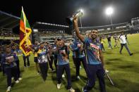 Sri Lanka's team members celebrate their victory over Australia by 3-2 in the one-day International series in Colombo, Sri Lanka, Friday, June 24, 2022. (AP Photo/Eranga Jayawardena)